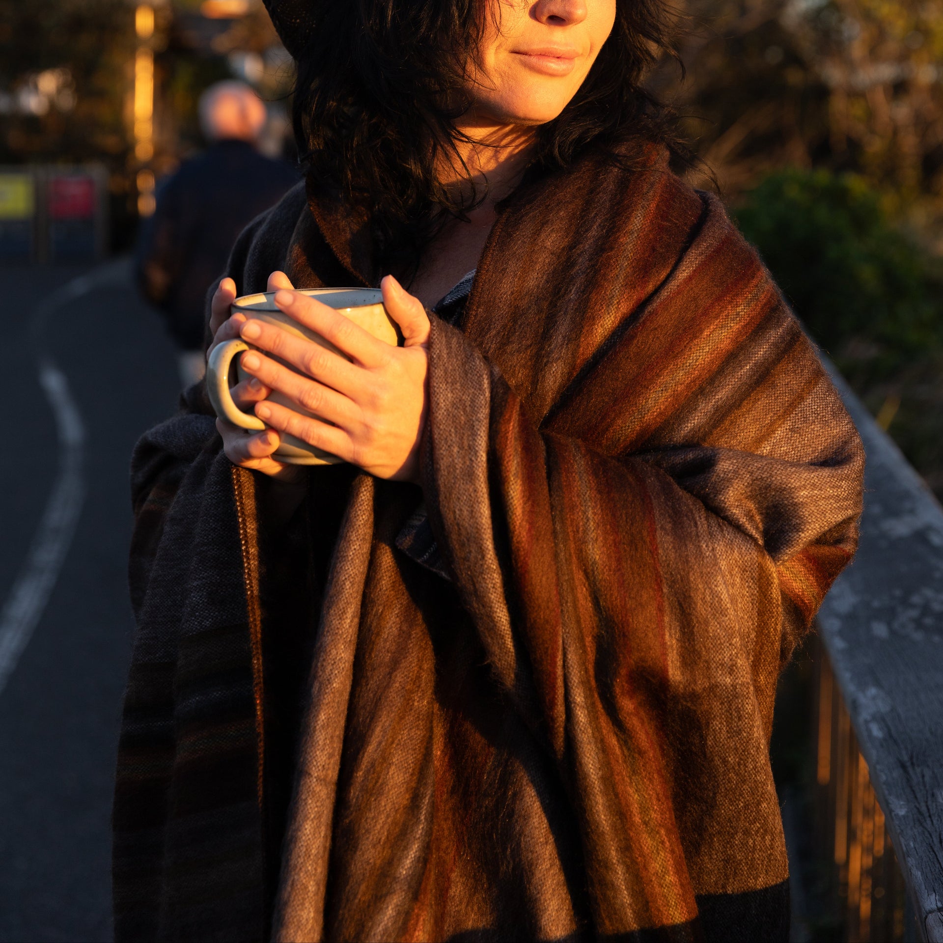 woman holding a mug wrapped in an alpaca wool blanket