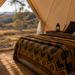 Wool Blanket with Aztec Pattern on a camping bed in Australian outback